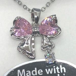 Beautiful Swarovski Crystals bow shaped. 16”S.Steel chain w/2” adjustment